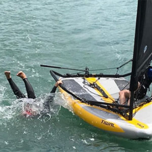 Kid falls into the water from his Tiwal 3 sailboat