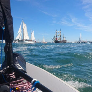 Pocket Sailboat Among Old Rigging Boats